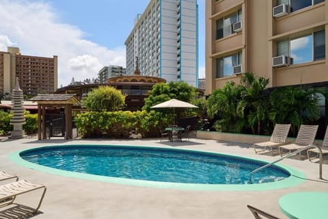 Relax in tropical shade while overlooking the calm pool.