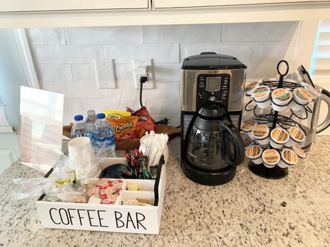 Coffee bar provides teas, coffees, bottled water, snacks and fixings.