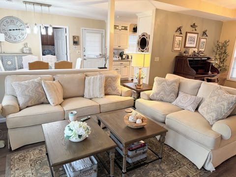 This cozy living room has cushy seating & a view of the pond. Also a large TV.