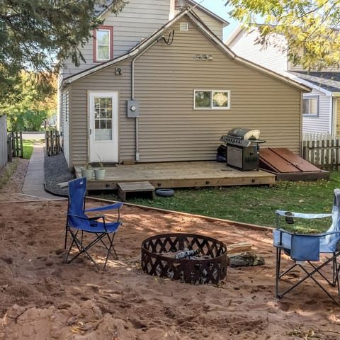 Rear of house with fire ring and grill.