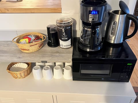 Coffee maker & grinder with locally roasted beans. Tea kettle with assorted teas