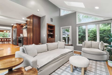 Living room at the middle level together with kitchen, dining area and  home gym room.