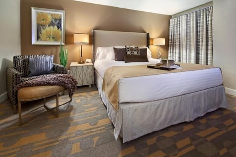 Unwind in a plush bed with warm, restful lighting.