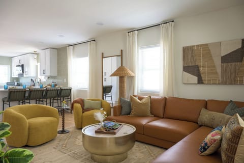 Bright, stylish living room with comfortable seating, Smart TV, and plenty of natural light — perfect for relaxing after a day exploring Denver.