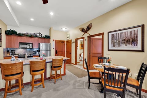 Fully stocked kitchen and dining area with bar seating and a dining table that seats 4.