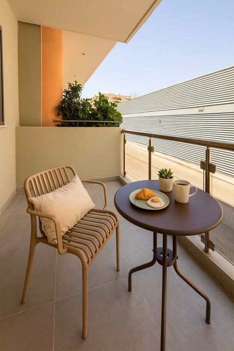 Balcony with Outdoor Dining Setup – Private balcony with table and chairs, perfect for relaxing moments.