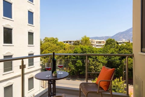 Balcony with Outdoor Seating and Greenery View – Private spot with outdoor furniture, ideal for coffee.