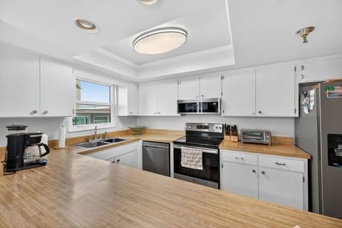Modern kitchen w/ stainless appliances, clean counters & plenty of prep space.