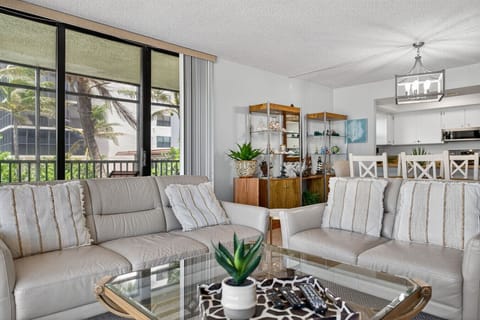Inviting living area w/ plush seating, soft textures & greenery bringing the outdoors in.