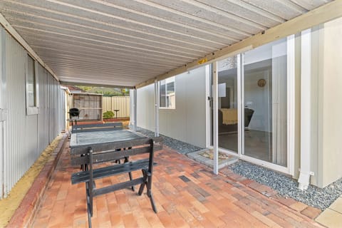 Enjoy the fresh air on your private patio, featuring a dining table and a BBQ grill—perfect for coffee or alfresco dining.