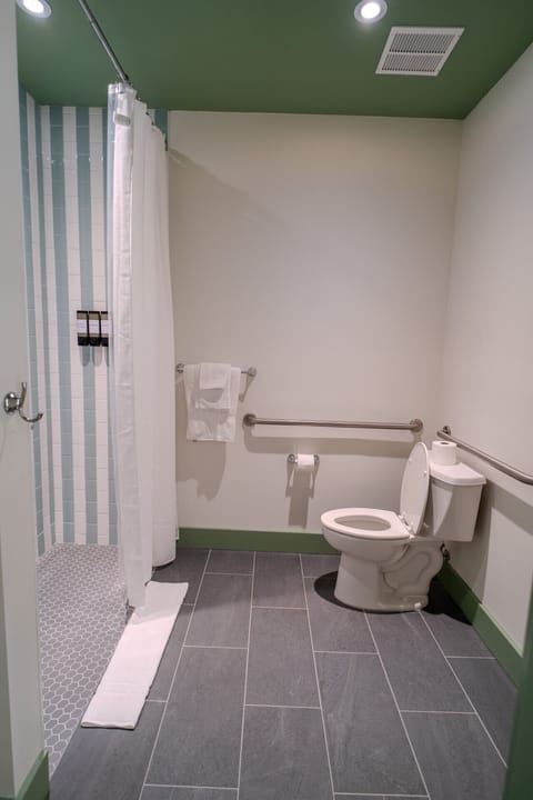 Modern bathroom with walk-in shower, safety bars, and custom tilework — perfect for added comfort