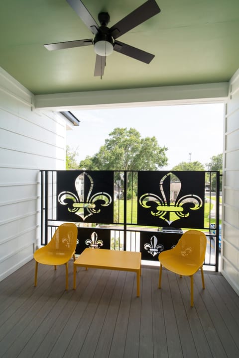 Private balcony with fleur-de-lis accents and seating — unwind outdoors