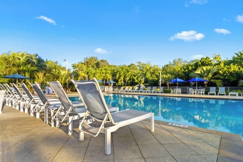 Soak up sunshine from a lounger beside the calm pool.