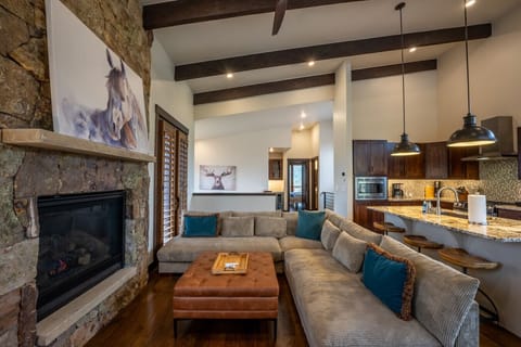 Living area featuring a gas fireplace, smart TV, & a spacious sectional