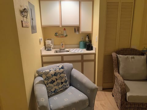 2 big comfortable chairs-blue chair swivels-whicker chair waterproof cushions.