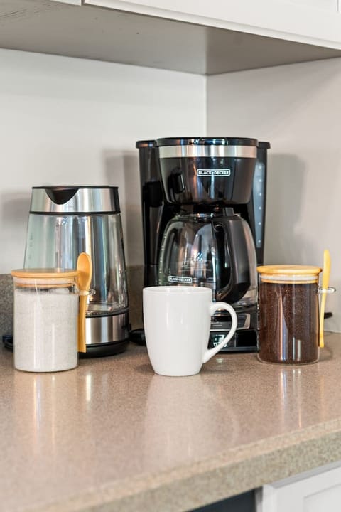 Countertop coffee setup with electric kettle and drip coffee maker.