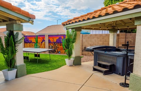 Escape to your own private retreat where fun and relaxation come together. Challenge friends to a game of ping pong, then unwind in the hot tub under the shade of the gazebo. Surrounded by vibrant murals and cozy spaces, this backyard is designed for