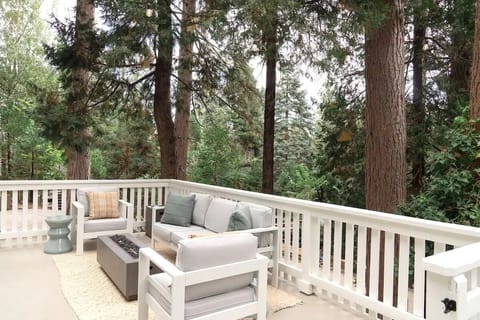 Front deck with string lights and firepit.