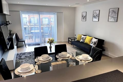 Light-filled living room with sofa and dining - modern Colindale apartment 