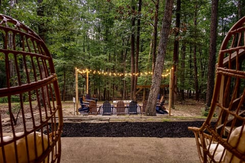 An enchanting fireside retreat—string lights, forest views, and the perfect setting for unforgettable evenings. Your private escape awaits.