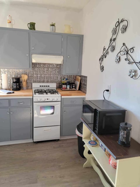 Kitchen counter, range, microwave and coffee/tea bar