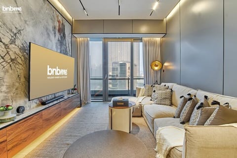 "The living room features a comfortable sofa and a large TV, creating a perfect setting for cozy movie nights and relaxed lounging"