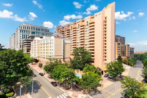 Arrive to a prominent hotel exterior in a vibrant district.