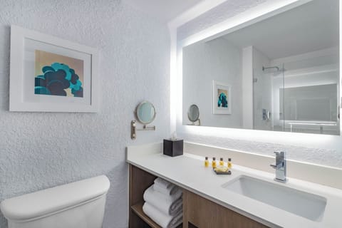 Refresh at a sleek vanity with bright mirror lighting.