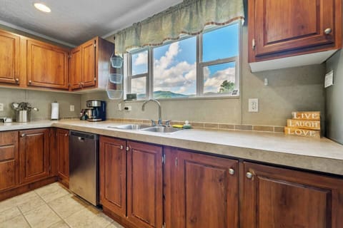 Enjoy a fully equipped kitchen featuring sleek stainless steel appliances and sink.