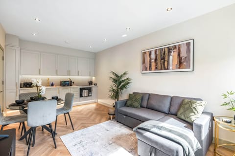 Bright living area with Smart TV, comfortable seating, and a double sofa bed.
