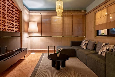 Unwind in our unique colonial living room: comfy sofa, TV, inviting light.