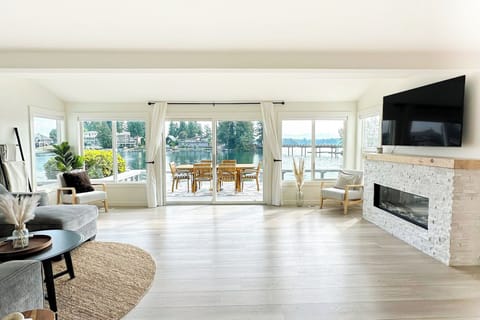 Living room with lake views and direct access to the deck and outdoor dining