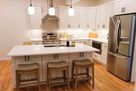 Bright, open concept kitchen with new appliances & ample counter space.