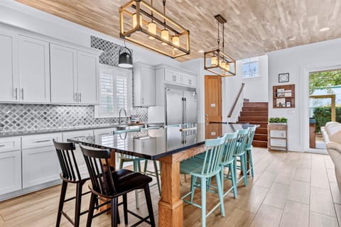 1st Floor – Spacious dining room and gourmet kitchen with premium appliances, large island, and plenty of seating. Perfect for family meals, entertaining, and group gatherings during your Miramar Beach vacation.