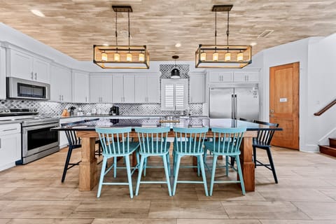 1st Floor – Spacious dining room and gourmet kitchen with premium appliances, large island, and plenty of seating. Perfect for family meals, entertaining, and group gatherings during your Miramar Beach vacation.