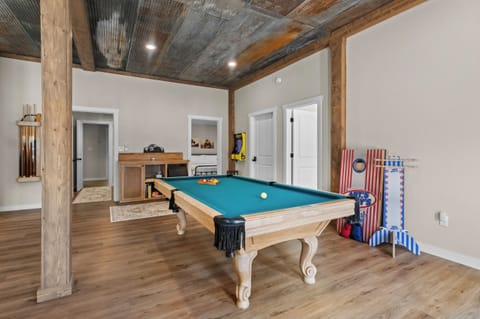 Game room with pool table, arcade game, corn hole boards, ice maker, & more!