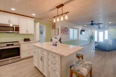 An open-concept kitchen with an island and stools, seamlessly connecting to the living room for easy entertaining.