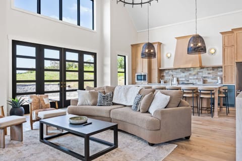 Living Room 1: Imagine cozy evenings spent on this plush sofa, surrounded by natural light and elegant design. This living room is the heart of your home away from home.