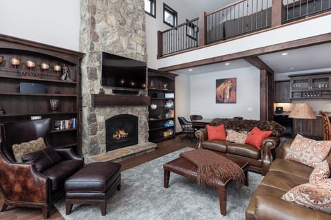 Comfortable living area with leather furniture and fireplace