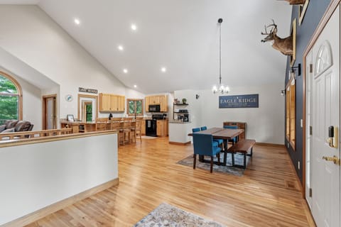 Gather around the spacious dining table while the chef prepares meals in your fully equipped kitchen with warm wood tones.