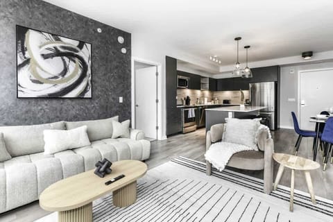 Chic and bright living room with cozy couch, flatscreen Tv and dedicated work station