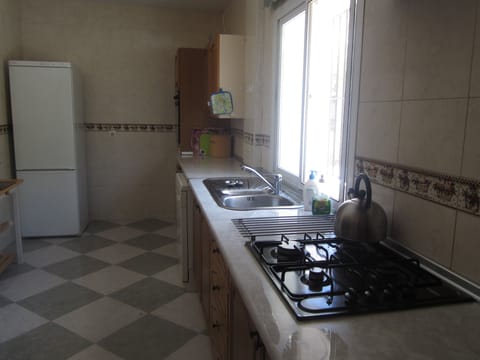 A view of the kitchen, fridge-freezer; gas hob; kitchen units; work-top.