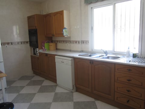 The kitchen; dish-washer; kitchen units; ovens; work-top.