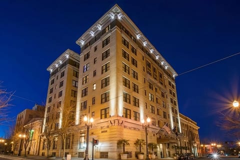 Arrive to a beautifully lit landmark façade at dusk.