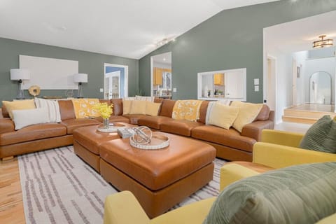 A huge couch big enough for everyone to see the 85 inch tv!