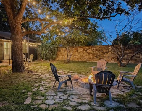 Covered patio with lounge chairs and string lights for a cozy night 