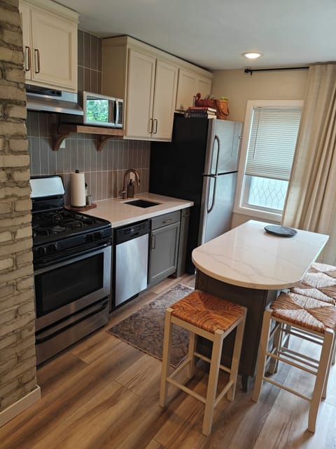 Newly remodeled kitchen equipped with appliances, dishware and supplies