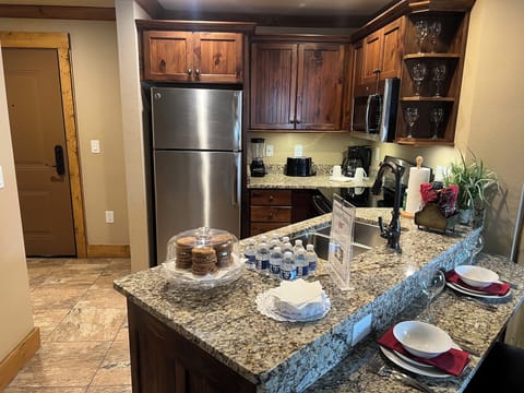 Kitchen, fully furnished. one of the 2 entrance doors seen on left. 