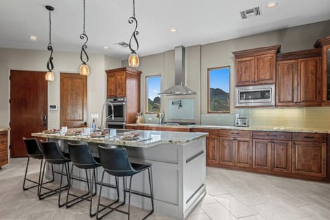 Four barstools at the oversized island—morning coffee, evening wine.
