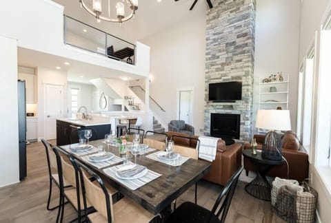 Your modern kitchen flows seamlessly into the living space, featuring soaring ceilings and mountain views that inspire your culinary adventures.